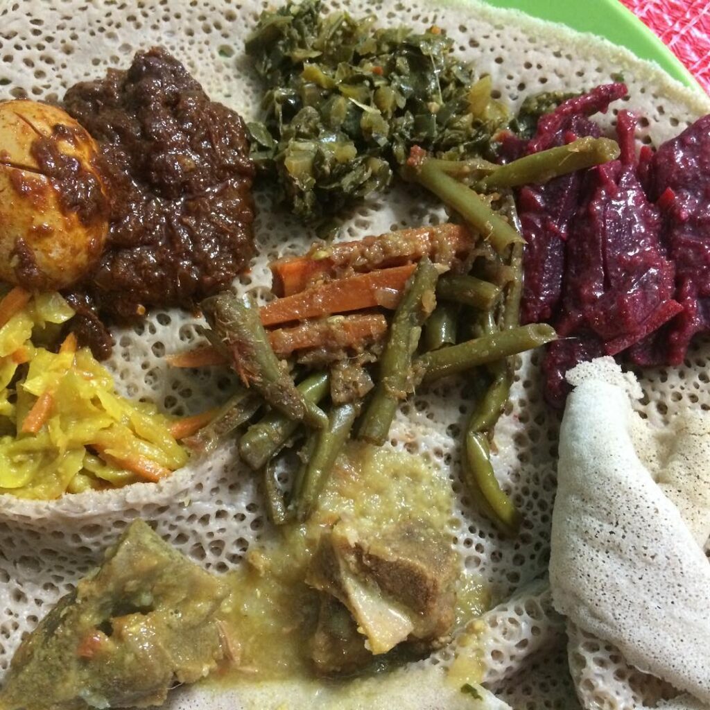 A sampling of traditional Ethipian food including Doro Wat and Gomen.
