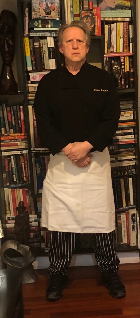 Chef and Author Alan Lake with a library of books.