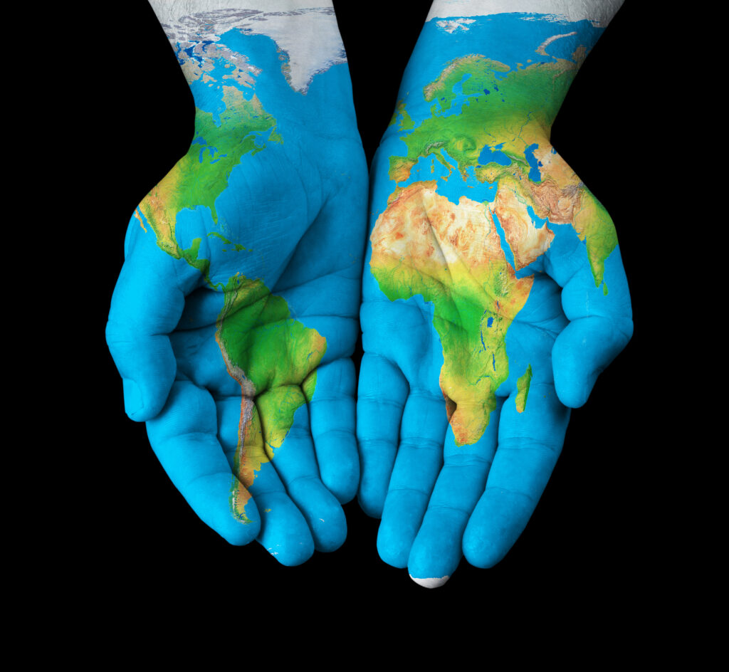 Whole world in your hands with map painted on hands.