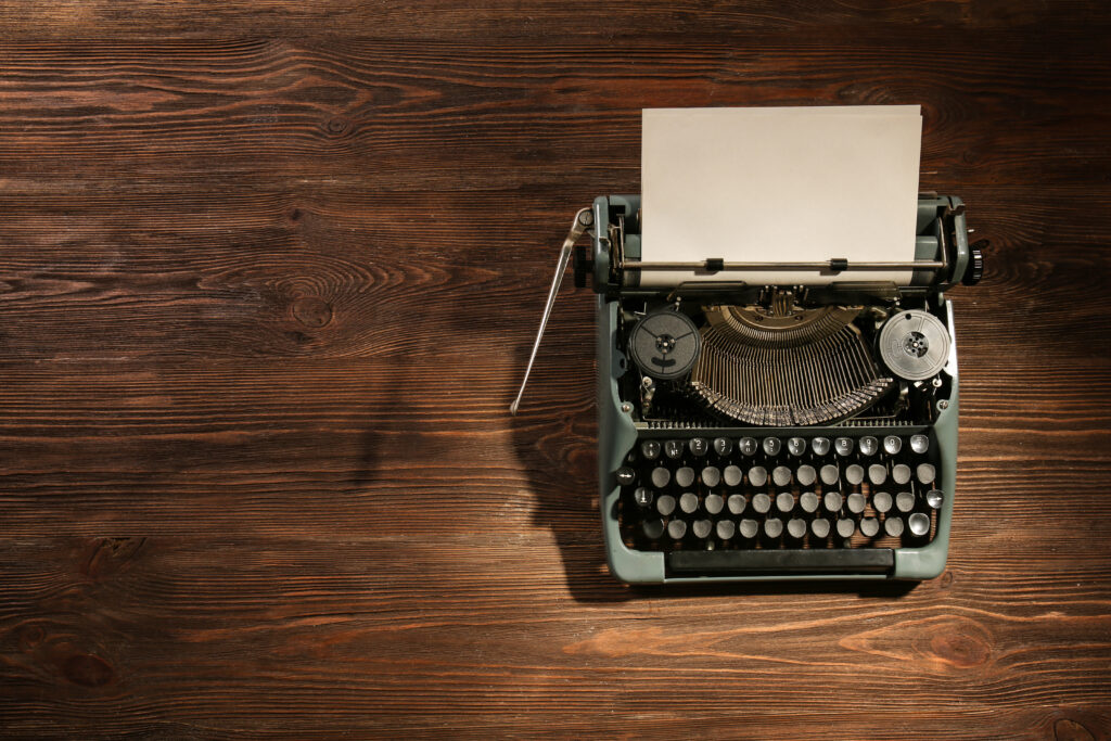 Old school typewrite on a weathered wooden table