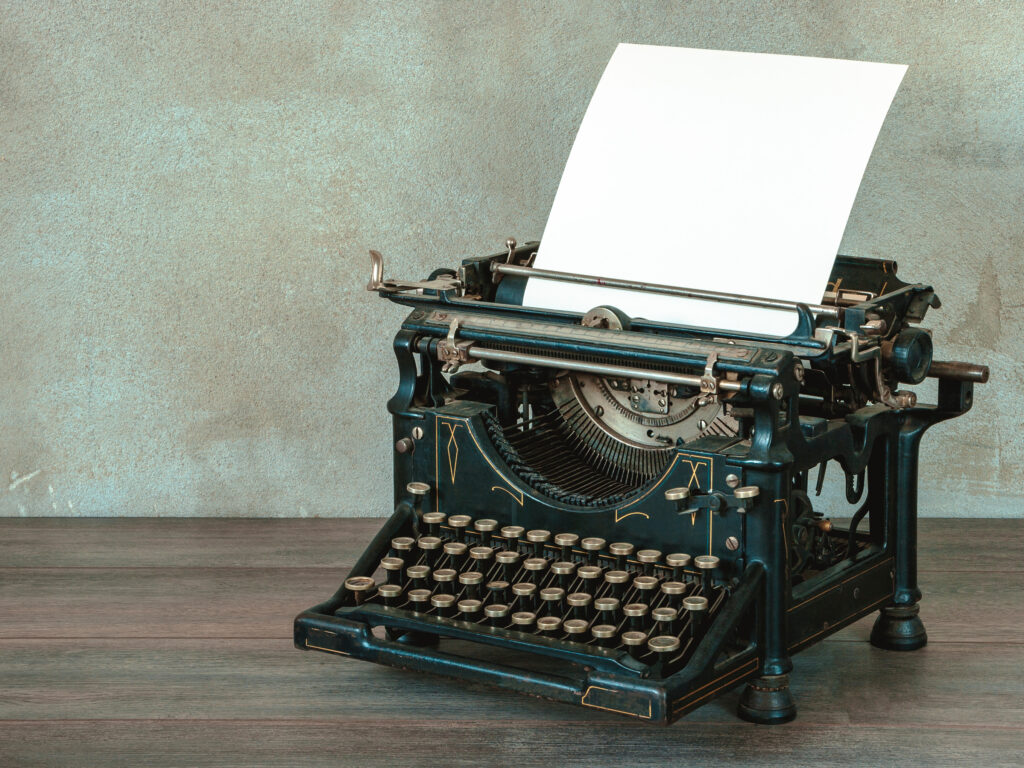 The old typewriter with a blank sheet of paper